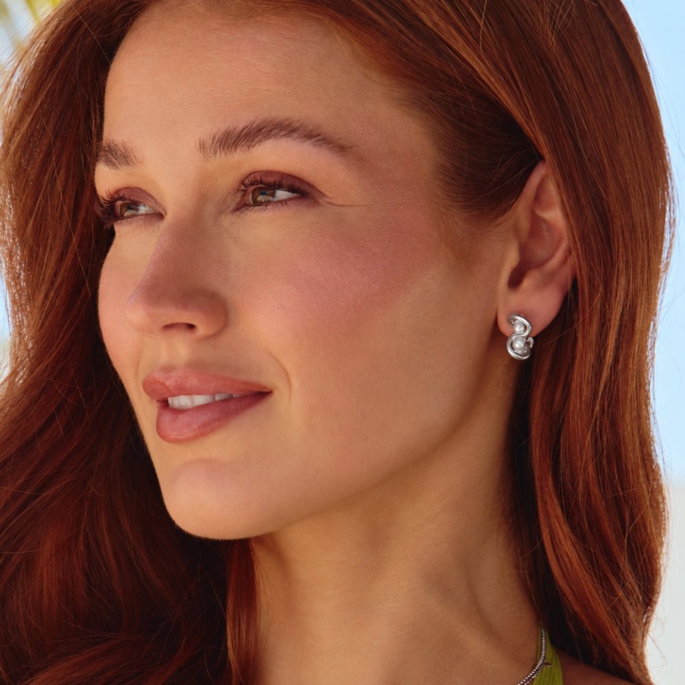 Tara Silver Entwined Pearl Earrings, worn on an ear by a woman with auburn hair, in profile